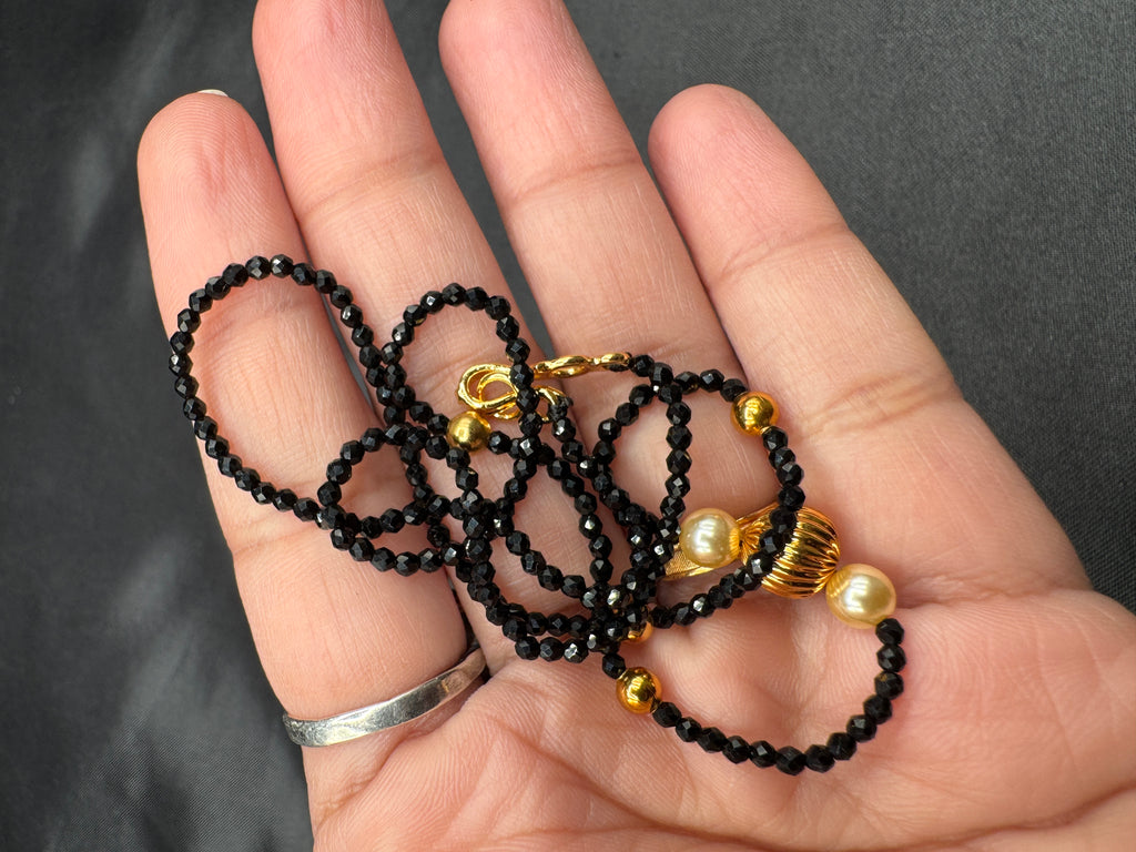 Single line black diamond bead with small gold ball and pearls
