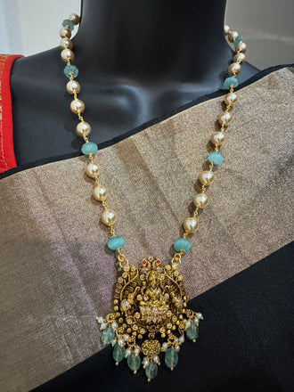 Antique Lakshmi pendant with pumpkin beads and a pearl chain