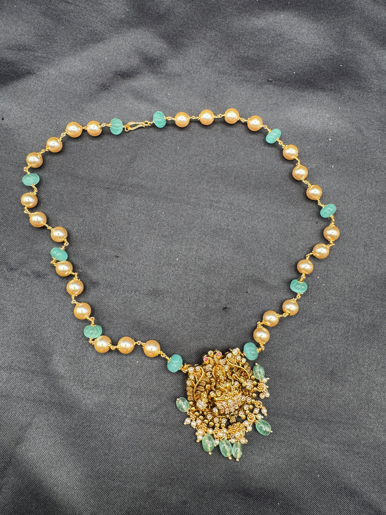 Antique Lakshmi pendant with pumpkin beads and a pearl chain
