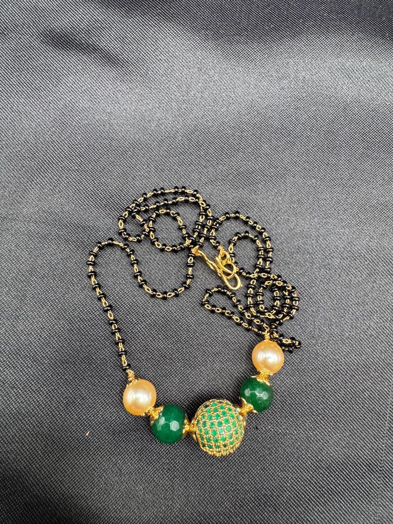 Green stone ball and Swarovski pearls with a single line of black bead chain