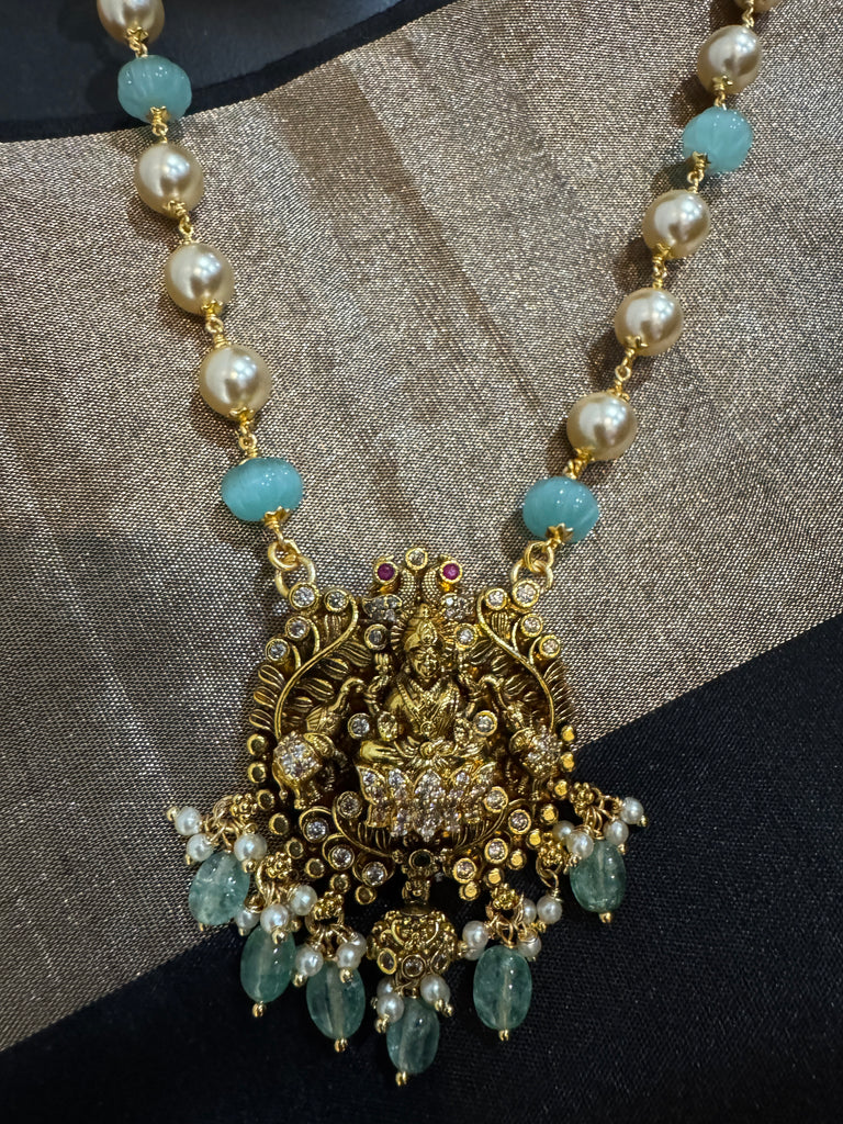 Antique Lakshmi pendant with pumpkin beads and a pearl chain