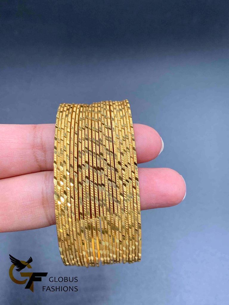 Set of 24 gold self design bangles