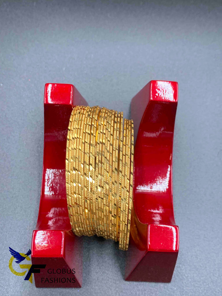 Set of 24 gold self design bangles