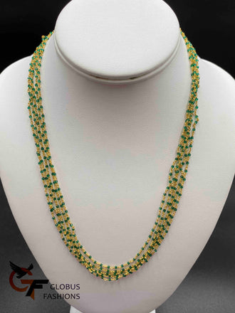 Bunch of green crystal beads twisted with gold chains