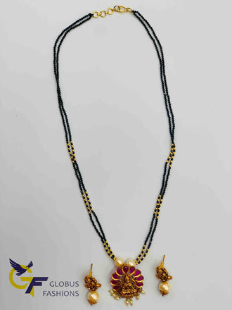 Traditional and antique look Lakshmi print with ruby and pearls pendant set with black diamond beads chain