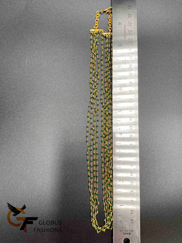 Bunch of green crystal beads twisted with gold chains